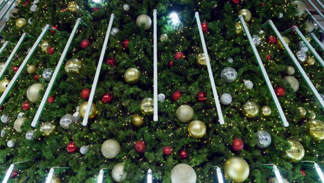 Glittering-Christmas-lights-adorning-a-giant-tree-on-display-inside-a-shopping-mall-in-Bangkok,-Thailand