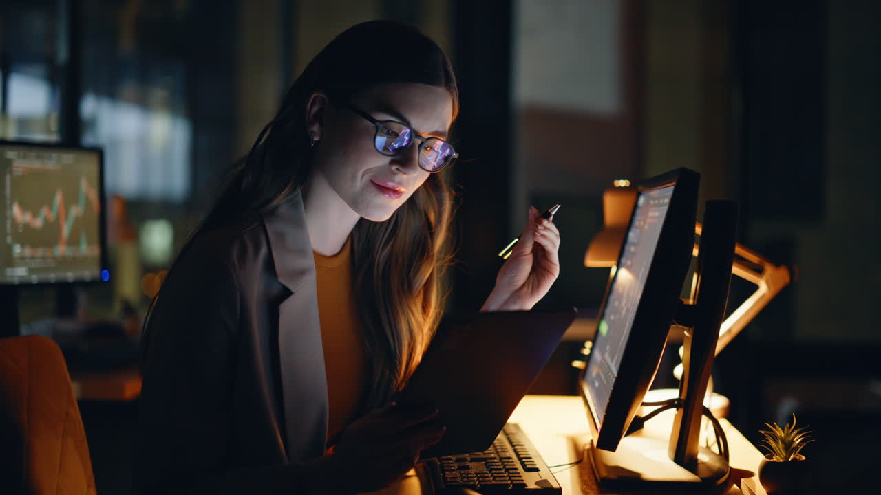 Night businesswoman trading cryptocurrency looking tablet at big office closeup