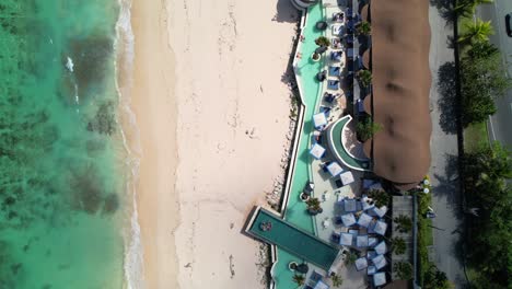 Tropical-Temptation-Beach-Club-by-iNi-Vie-Hospitality-in-Uluwatu-Bali,-Melasti-Beach,-Indonesia---Top-Down-Flyover