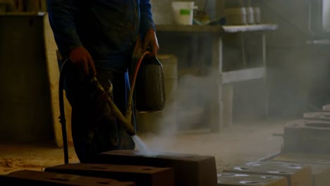 male water spraying water on heated molds in workshop 4k