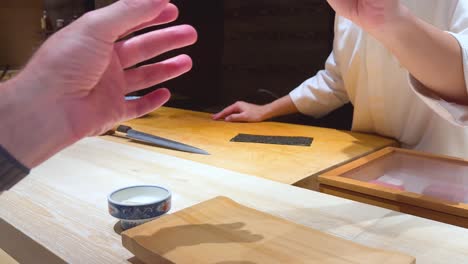 chef presents sushi to customer in bangkok