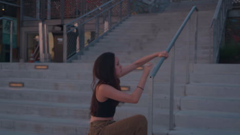 Young,-female,-contemporary-dancer-on-scenic-overlook-at-sunset