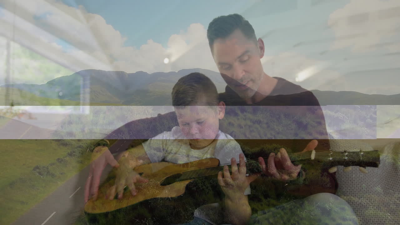 Father guiding son playing guitar in living room, using animated chord charts for music education
