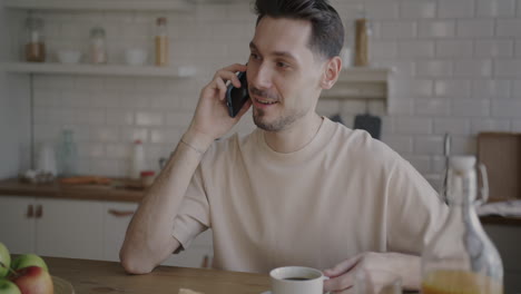 man talking on phone while eating breakfast
