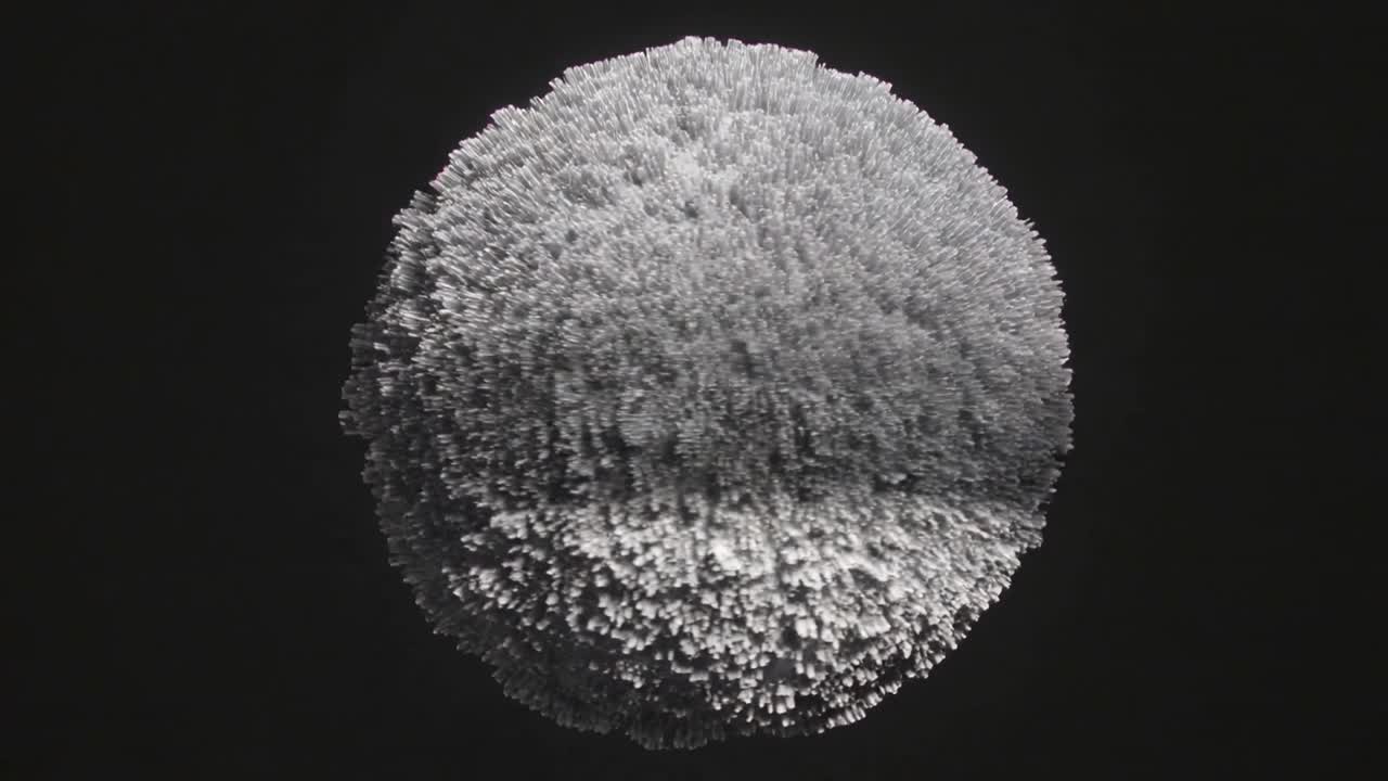 Frames starting gray orb growing spikes, orbiting in dark void under top-left light, forming fuzz