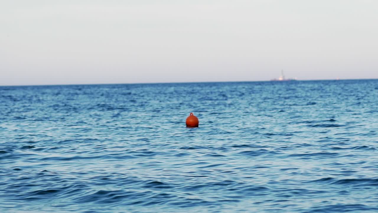 Buoy in the open sea. Lonely buoy in beautiful blue sea