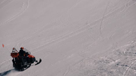 person going uphill on a snowscooter