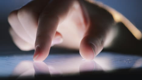 closeup finger touching tablet computer touchscreen