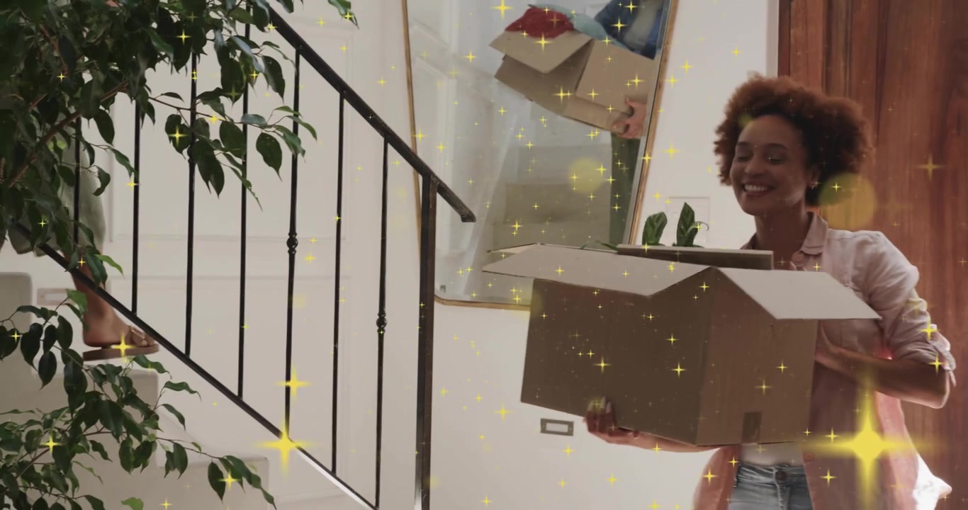 Sparkle filter lighting foyer woman tossing box down stairs to friend catching plant for home move