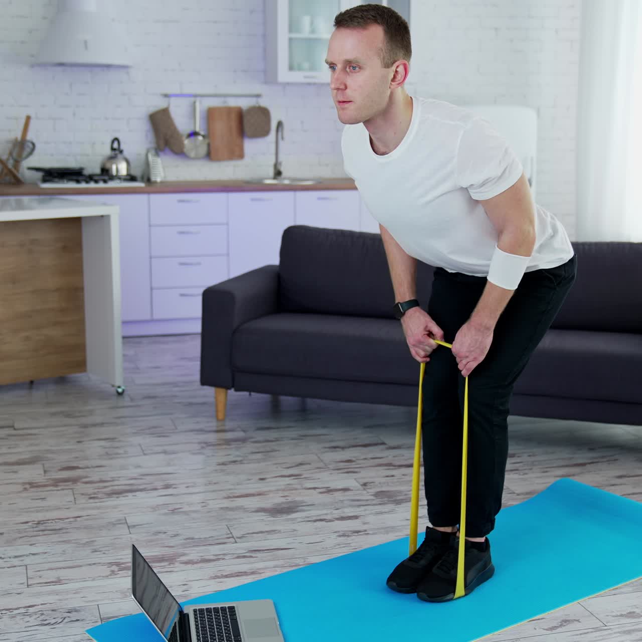 Lifestyle strong man training his body in home. Quarantine man doing exercise indoor