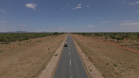 breathtaking drone view of a jeep navigating namibia's vast landscapes, showcasing stunning deserts, rugged terrain, and endless horizons in an epic adventure through nature's beauty.