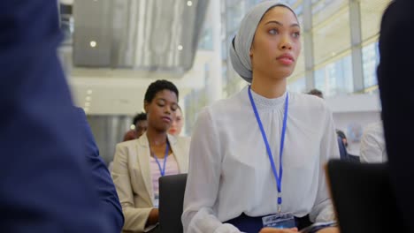 mixed-race businesswoman raising hand in the business seminar 4k