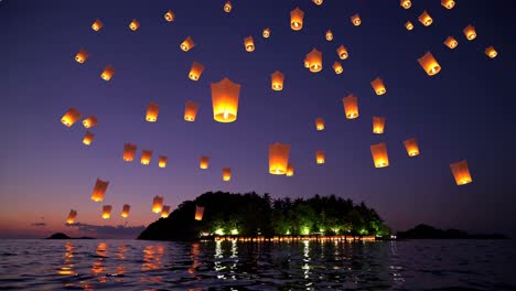 sky lanterns over tropical island at sunset