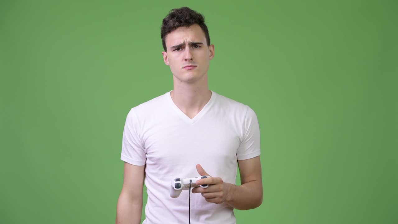 Young handsome man playing games while using virtual reality headset