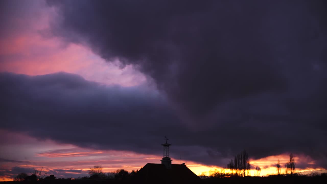cumulonimbus big cloud moving at sunset time lapse silhouette clock tower central