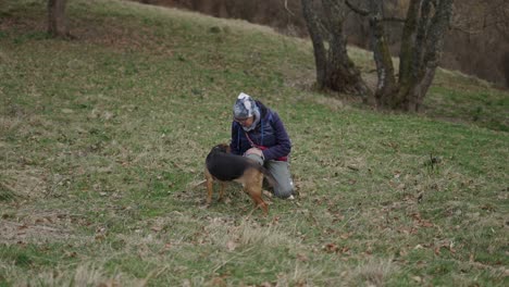 man and dog hiking in forest