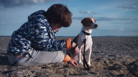 4k outdoor seaside child and dog posing on beach