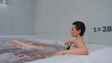 woman relaxing in a modern hot tub