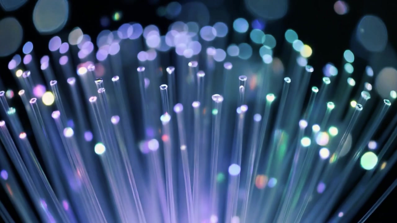 Glowing Fiber Optic Cables with Abstract Light Bokeh