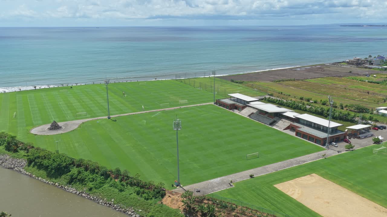 Luftfoto af Bali United træningscenters fodboldbaner ved havet