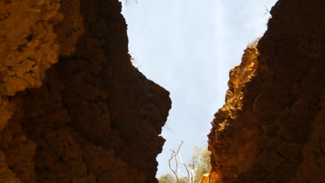 the roof of a cave has eroded away leaving a large hole stretching up to the surface above