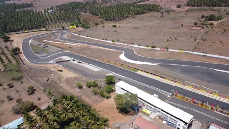 Panoramic-aerial-view-of-Kari-Motor-Speedway-Racetrack-in-Chettipalayam,-Bike-racing-event-on-the-track,-Coimbatore,-Tamil-Nadu,-India