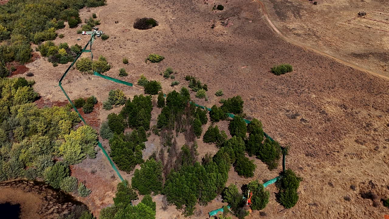 Chopper push herd of wildebeest successfully into boma, high aerial view