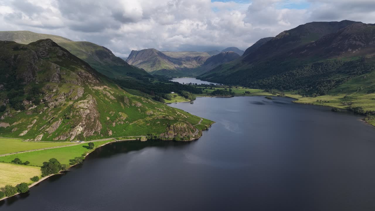 Stunning aerial reveal of the Buttermere Valley, Rannerdale Knotts, Crummock water and sourounding Fells, Lake District, Cumbria, England