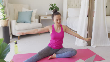 Happy-asian-woman-doing-yoga-and-stretching-in-bedroom,-in-slow-motion