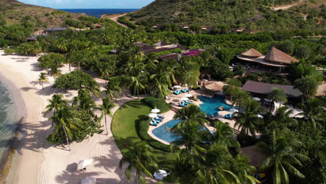 British-Virgin-Islands,-Flying-Above-Luxury-Beachfront-Resort-and-Landscape,-Revealing-Orbit-Drone-Shot