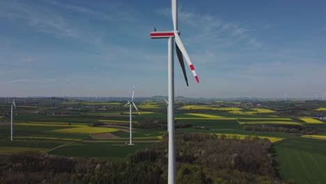 Aerial-View-Of-A-Newly-Constructed-Wind-Turbine---drone-shot-pullback