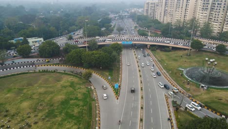 aerial drone shot showcasing the never-ending stream of cars on a delhi flyover, illustrating the city's fast-paced life.