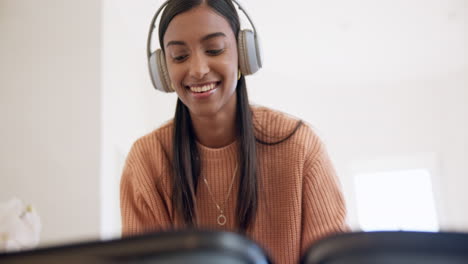 Headphones,-smile-and-woman-packing-suitcase