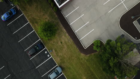 dynamic aerial topdown over rooftop and parking lot