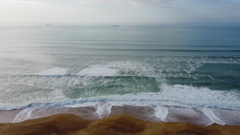 aerial-shot-of-the-wild-beach-of-french-landes,-relaxing-image-in-blue-and-brown-tone