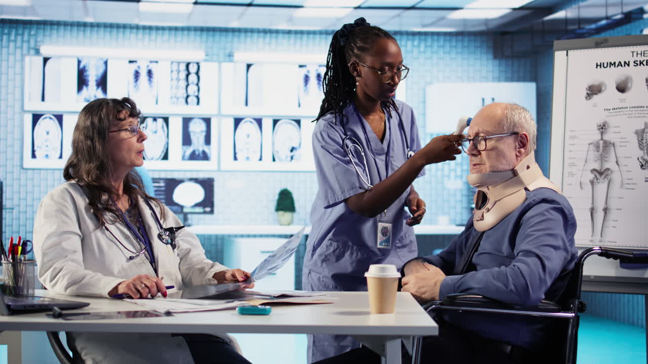 Vertical Video Medical staff consults old man wheelchair user wearing cervical neck collar