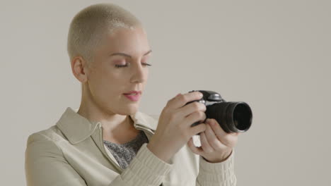 young woman using a digital camera against white background 01