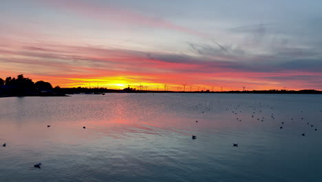 Colorful-Yellow-and-Pink-Riverfront-Sunset-in-Puck,-Poland