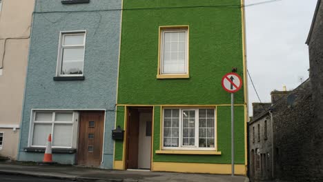 Top-down-shot-of-some-buildings-or-houses-with-the-blue-and-green-facade-in-Gort,-Ireland