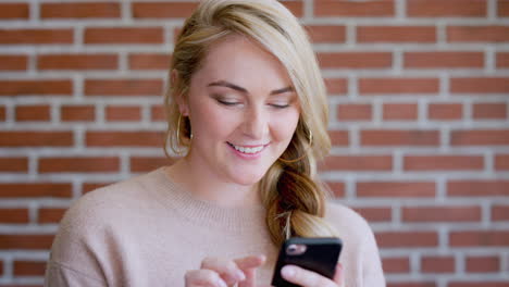 Woman,-phone-and-smile-or-typing-with-brick-wall