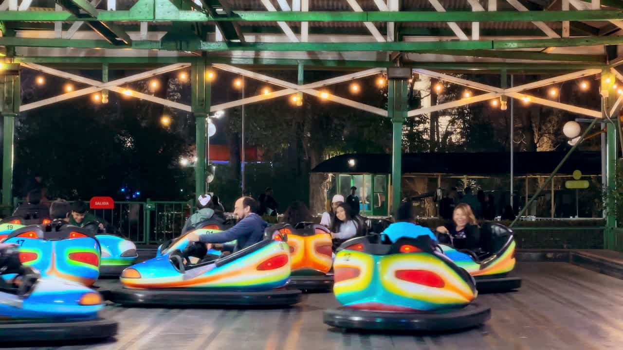 Bumper car games with a group of people enjoying family moments at the Fantasilandia park, Santiago, Chile.