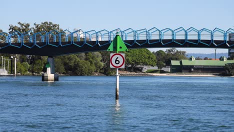 bridge and canal with speed limit sign