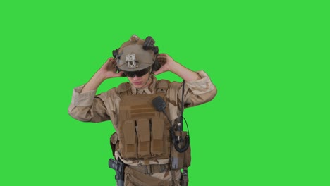 soldier preparing tactical gear for action battle on a green screen, chroma key