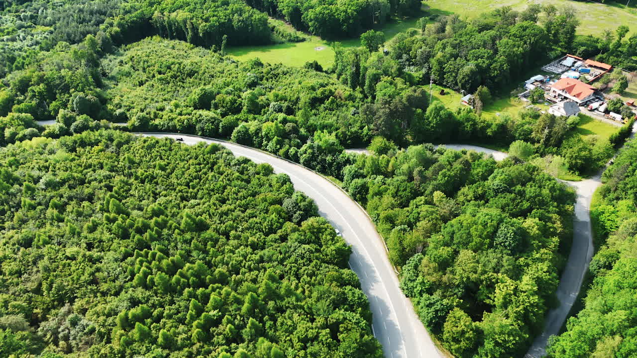 Amazing lush greenery of the woods crossed by the highways. Beautiful countryside of Slovakia from top view
