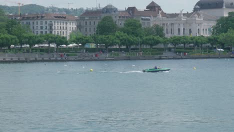 tracking shot of a sport boat navigating the river canal in zurich, switzerland