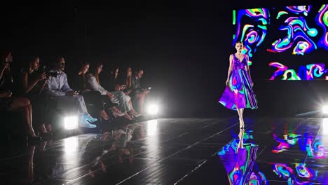 fashion show model in colorful dress on runway