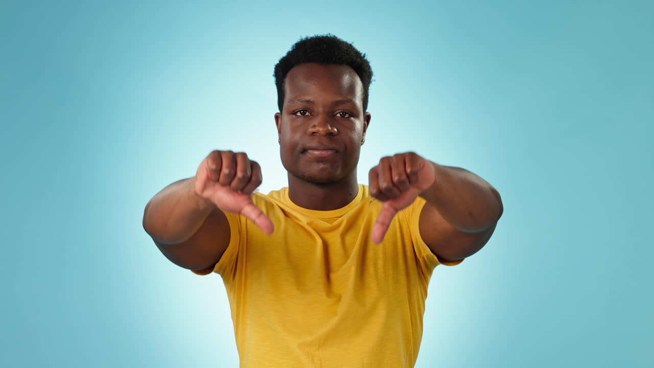 Thumbs down, face or man in studio with no sign