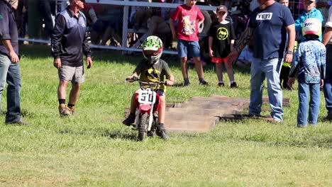 child motocross rider prepares and starts race