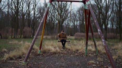lonely figure on an abandoned swing