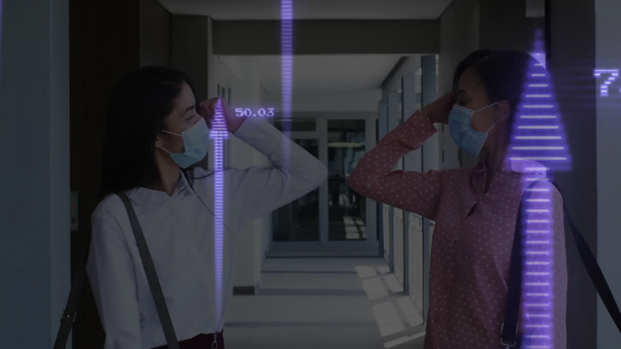 Wearing masks, two people in school greeting with animation data graphics overlay